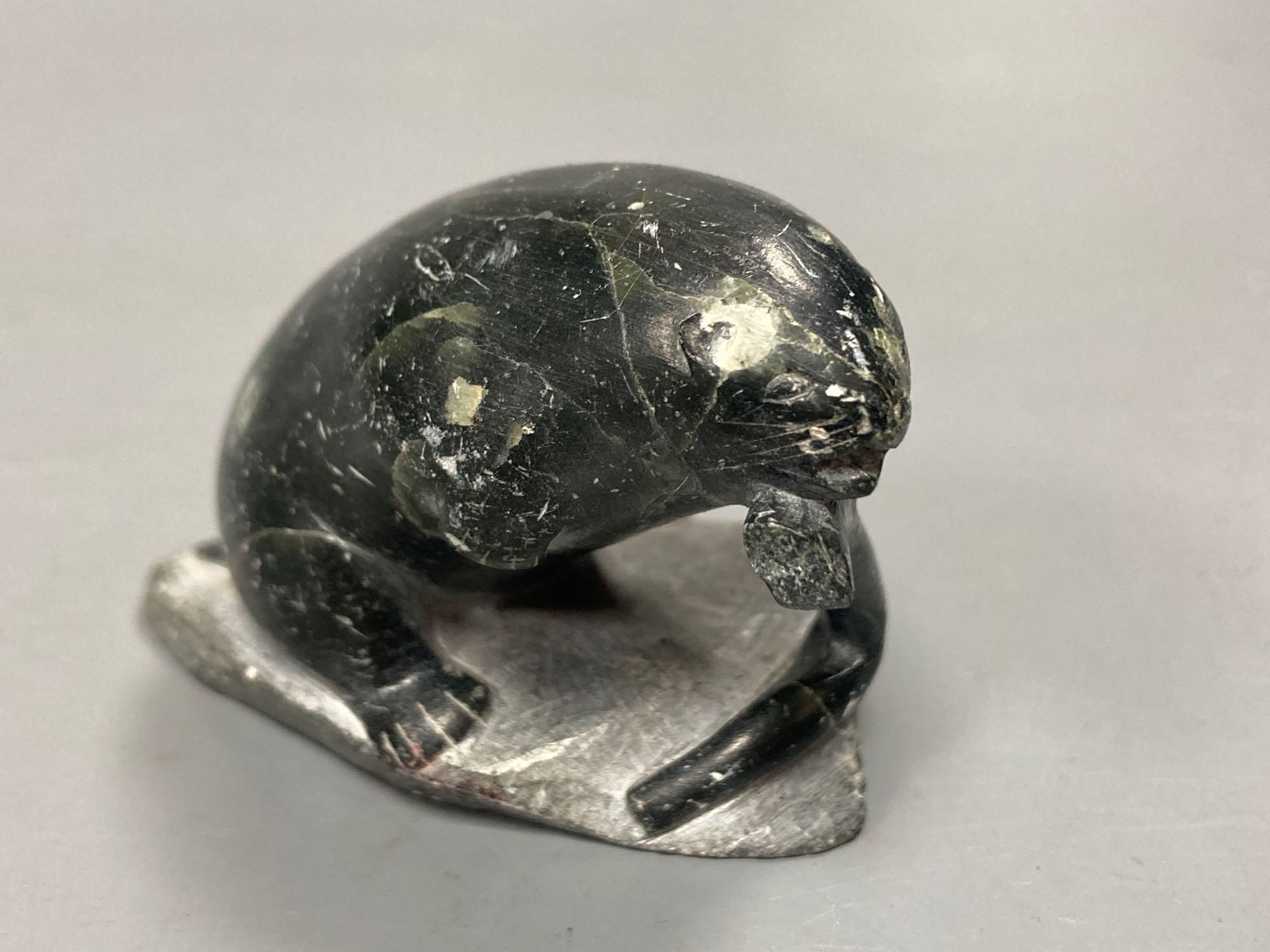 A carved inuit sculpture of a seal, signed Markossie SCP, 5cm high